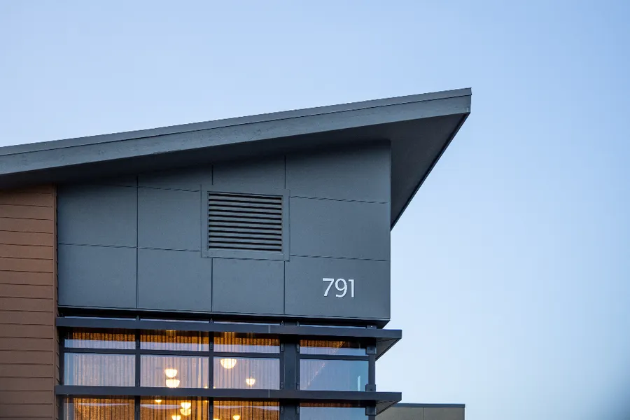 The clean roofline of a modern house against a clear sky.