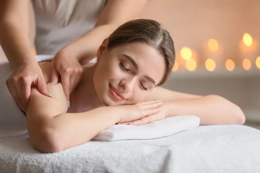 A client relaxing during a massage at a wellness studio.